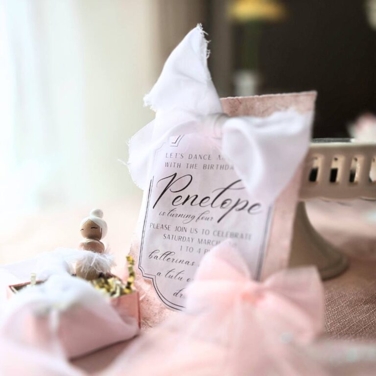 Pink birthday party invitation and a wooden peg doll ballerina party favor