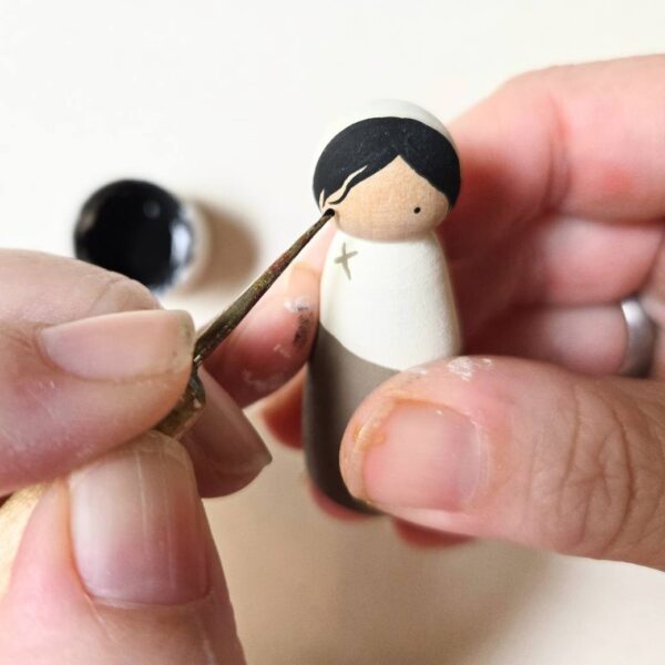 Eyes being painted on a "Mary" peg doll